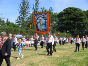 Wilson Beggs - Worshipful Master (left) and Walter Erwin - Secretary (right) pictured leading Quilly True Blues L.O.L. 442 into the demonstration field in Loughbrickland on 12th July 2005