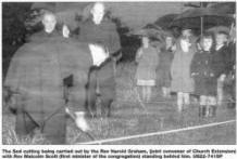 The Sod cutting being carried out by the Rev Harold Graham, (joint convenor of Church Extension) with Rev Malcolm Scott (first minister of the congregation) standing behind him. US22-741SP