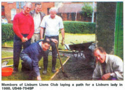 Members of Lisburn Lions Club laying a path for a Lisburn lady in 1988. US48-754SP