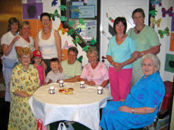 Pictured enjoying Morning Coffee at the Aghalee Parish Fair on Saturday 10th June is L to R: (seated) Jean Mathers, children - Ellen and Edward Doogan, Meta Bell, Edith Dougan and Susan Wilson. (back row) Joy Frazer, Lesley Payne, Irene Culbert, Diane Mather and Helen Laird.