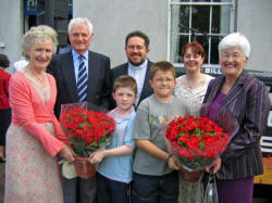 Adam and Stuart Walker pictured presenting gifts to Mrs Maureen Patton (left) and Mrs Eleanor Walsh (right) at the opening of the Garden Party at Kilwarlin Moravian Church on Saturday 10th June.  Also included is L to R:  (back row) Fred Walsh, Rev Paul Holdsworth and Patsy Holdsworth. 