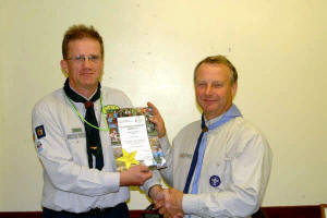 Noel Irwin - District Commissioner pictured presenting a Volunteering Achievement certificate to Mervyn Fleming - 1st Derriaghy Scout Group.