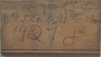 Close up of the piece of wood found in the cavity wall of the building, the hand written note says, �In the year of our Lord - 6th Dec to 21st Nov 1927�, it is unclear what the last symbol is. It looks like �d� - perhaps it is the builder�s initial.