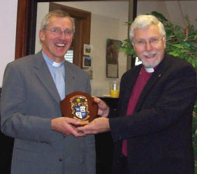 Bishop Harold Miller is pictured presenting a diocesan crest to the Very Rev John Dinnen at the Diocesan Council lunch.