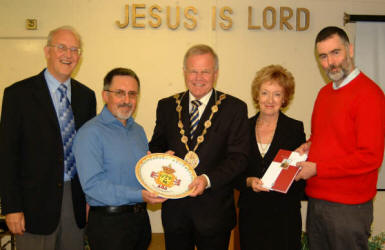 Church elder Stuart McDowall and church secretary George Allen, a member of the local music group �Slemish� are pictured passing on gifts that the band received from Spanish Cultural Ministers during the band�s trip to Spain on Monday 10th to Tuesday 16th October. L to R: John Miller, George Allen, the Mayor - Councillor Trevor Lunn, the Mayoress - Mrs Laureen Lunn and Stuart McDowall. The picture was taken during morning worship in Lambeg Baptist Church last Sunday.