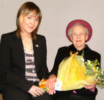 Kirsty Waddell is pictured presenting a bouquet of flowers to Mrs Babs Fox who opened the new Magheraknock Mission Hall last Saturday afternoon (11th November)