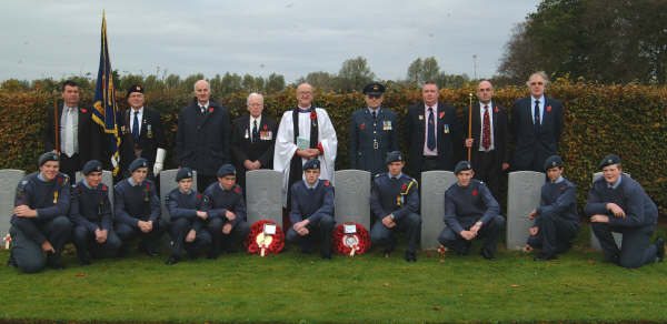Pictured at the twenty-one Commonwealth War Graves at Eglantine Parish Church are L to R:  (back row) Maurice Hanna (People�s Warden), Brian Fitzsimons (Standard Bearer - 31 Group, Royal Observer Corps Association), Paddy Malone, Wing Commander Harry Allen, the Rector - Rev Canon William Bell, Flt Lt Roy Kerr (OC 817 Lisburn ATC), David Orr and Geoffrey Simpson (Rector�s Warden).  Included in the front row are Cadets from 2004 Ballynahinch Squadron.