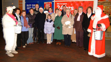 The Rev James Carson, Rector and members of St Paul�s Parish Church, Lisburn pictured Carol Singing at Tescos on Thursday 21st December to raise money for charities.