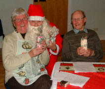 Eric Scott (right) looks on as Pat Hanna gets a big hug from Santa (Ian Barron) at the Senior Members� Christmas Tea in Railway Street Presbyterian Church on Saturday 2nd December.