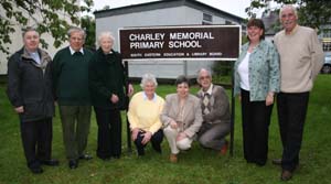 At the BBQ in Charley Memorial Primary School last Friday night are L to R: (standing) Rev Raymond Devenney (Rector of Drumbeg Parish), Col Robin Charley, Janet Charley, Gwen Forsythe (Principal 2001-present), Jimmy Sloan (Principal 1984-2001). (under the sign) Past acting principals - Marilyn Campbell,