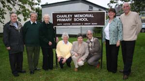 At the BBQ in Charley Memorial Primary School last Friday night are L to R: (standing) Rev Raymond Devenney (Rector of Drumbeg Parish), Col Robin Charley, Janet Charley, Gwen Forsythe (Principal 2001-present), Jimmy Sloan (Principal 1984-2001). (under the sign) Past acting principals - Marilyn Campbell, 