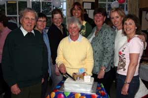 Mrs Marilyn Campbell is pictured cutting her cake last Friday night marking her retirement after almost 17 years of dedicated service to Charley Memorial Primary School. L to R: Col Robin Charley, Sandra Thompson, Shirley MacWilliam, Anne Crooks, Gwen Forsythe (Principal), Lynda Graham and Mabel Quinn (all past and present members of the PTA).