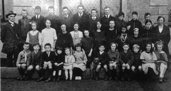 Year 1923 ? 1925: L to R: (back row) Master R Curd, William Drennan, William Livingstone, James Hamilton, William Turkington, Edward McMaster, William Henderson, Thomas Kerr, Robert Cowan, Angus Wilson and William Hamilton. (middle row) Esther Hunt, Daisy Crothers, Nell Dugan, Eileen McClinton, Molly Turkington, Jenny Allen, Mary Kerr, Florence Oliver, Marie Craig and Rita Wilson. (front row) John Hamilton, William J Adams, George Maxwell, Evelyn Dugan, Mantle Dugan, Louise Henderson, James Allen, Harriet Allen, John McClinton, Charles Foster, Whiteside and Sadie Cowan.