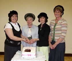 Miss Marjorie Boreland MBE (second from left) cuts a cake marking her retirement as organist of Hillsborough Free Presbyterian Church (1967-2007). Assisting her is L to R: Patricia Hamilton, Elizabeth Gardner and Ida McCready.