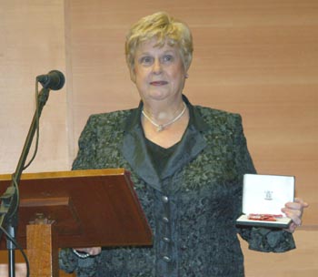 Norma Bell proudly shows her MBE, which she recently received for her services to the community as Chairperson of the Lisburn Action Cancer Group.