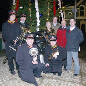 At the switch-on of the Christmas tree lights in Drumbo are (right of picture) Drumbo and District Community Association members Paul Gregg (Treasurer) and Ian Douglas (Chairman) with Councillor Betty Campbell and the Rev Adrian McLernon (Minister of Drumbo Presbyterian Church). Included in the photo are Salvation Army band members Nathan Moore and Adam Moore (left at back) and John Murdock and John Moore (kneeling at front).