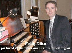 Phillip Elliott pictured at the three manual Snetzler organ.