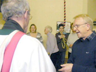 Alistair Jameson presents a gift on behalf of the Hillsborough Parish Bellringers to their long serving Rector, former Dean of Down, the Rev John Dinnen.