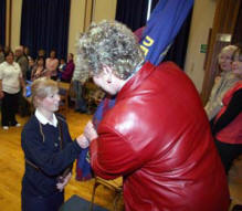 Victoria Shields presents the colours to the Rector, the Rev Donna Quigley at Derryvolgie Parish Girls' Brigade Display on Friday 25th April.