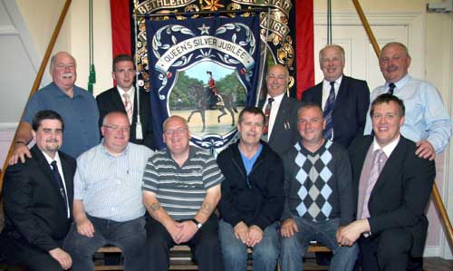 Scottish Orange Lodge No 1977 members L to R: Bro William Mullen (WM), Bro Walter Mullen, Bro Brian Burke and Bro Paul Edwards pictured with Bro Dr Jonathan Mattison (left), Bro Edward Hanna (right) and in the back row - Bro Norman Corbett, Bro Andrew Skelly, Bro Eric Jess, Bro Norman Biggerstaff and Bro Geoffrey Dickson.