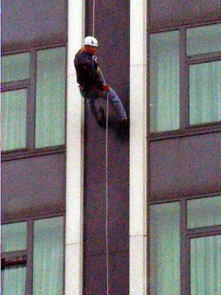 Heavens above - it's the Vicar. Lisburn Cathedral Vicar, the Rev Kenneth McGrath pictured clocking up the fastest time of just 1minute and 8 seconds as he abseils down the Europa Hotel, Belfast on Saturday 27th September to raise funds for Lisburn Cathedral. 