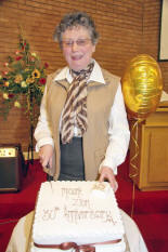 Founder member Jean Mitchell cuts the 30th anniversary cake.