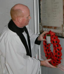 Rev Ken McGrath (Vicar) lays a wreath at the Memorial Tablet in Lisburn Cathedral erected in memory of the men from the Parish who fell in the Great War 1914-1918.