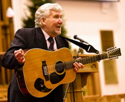 Noel McMaster of Bakerloo Junction sings his new song 'Barbour Mill' a few feet away from the seat occupied by William Barbour JP, who died in 1875.