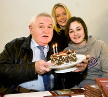 Happy 60th Emma and Laura Kelly help their old Dad blow out the candles on a cake presented by Catherine O'Reilly, Secretary of the Bakerloo Junction fan club.