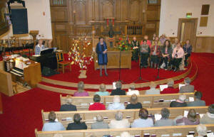 Jean Gibson (leading the service) is pictured with Dr Bertha Cowan (at piano) and the combined choir comprising of ladies from churches in the Lisburn area who led the praise at the ‘Women’s World Day’ of Prayer service in Railway Street Presbyterian Church.