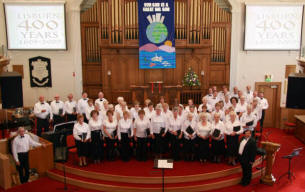 The City of Lisburn Combined Choirs pictured with accompanist Gordon Myers (left) and conductor Tom Whyte (right).