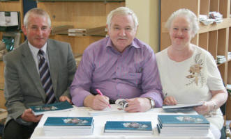 John is pictured signing copies of his book for John Gillespie and Beth Harrison at a ‘book signing’ morning in the Lisburn Museum Book Shop on Saturday 13th June. 