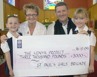 Treasurer Linda Dickey and girls from St Paul’s Girls’ Brigade present a £3000 cheque for the St Paul’s Kenya Project to team leader, the Rev Jim Carson.