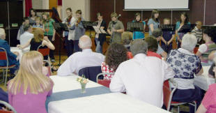 Oswald Copes and the praise band leading the lively singing.