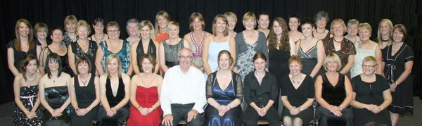 Conductor Emma Collins and accompanists Richard Irvine (piano) and Philip McKibben (percussion) pictured with the ladies of Rhythm & Rhyme prior to taking to the stage at Laurelhill Community College last Friday evening (11th September). 