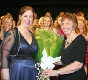 Emma Collins receives a gift from her mother Liz (also a choir member) in appreciation of her hard work in training and conducting the concert. 