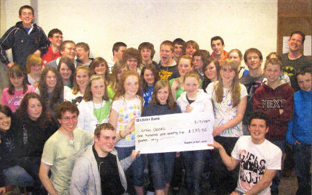 Members and leaders of Revelation, (St John's Moira Youth Fellowship) who raised money with their sponsored Stay Awake for Open Doors charity — who raise awareness and help to serve persecuted Christians around the world. Presenting the cheque to Dave McCann (bottom left) of Open Doors is Simon Henry (bottom right), Youth Ministry Coordinator.