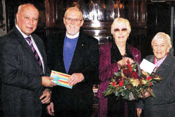 Mr. Perry Reid (Clerk of Session) and Mrs. Irene White (wife of former Clerk of Session, the late Mr Norman White) presenting gifts to Dr. & Mrs. Gray.