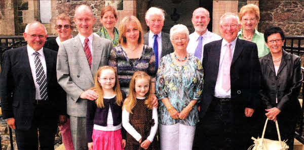 Drumbeg Residents Association Chairman Hugh Crookshanks (left) and his sister Emily Davis (right) at the Community Service with Raymond and Suzanne Reid and family and former Drumbeg residents Frank and Christine Flynn who now live in Australia.