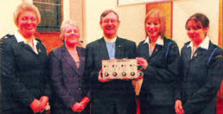 Presenting a gift to the Rev David Porter (Chairman) and his wife Norma are GB Captain Karen Carson (left) and GB 0fficers, Sarah Parkinson and Helen McAuley (right)