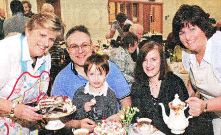 Margaret Artt and Karen Elliott serving up a Christmas treat of tea, scones and speciality cakes on vintage china to Stephen and Fiona Johnston and their son James at a fundraising event 'Let Them Eat Cake!' in Railway Street Presbyterian Church.