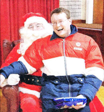 Rev. Gareth McFadden gives Santa his Christmas list.