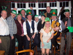 Drew Rowan (left) and Noel McMaster of Bakerloo Junction pictured with some of the many Irish music enthusiasts at the Ivanhoe Hotel on St. Patrick�s night.