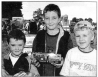 RIGHT: Looking for a bargain at the Harry Ferguson Celebration Committee Show at Growell are Luke McArney, Mark McArney and Matthew Starrs. BL34-412SM