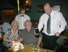 Cormac Judge and Tom Whiteside pop open a bottle of champagne for Nelson and Pat Williams as they celebrate their 50th wedding anniversary.