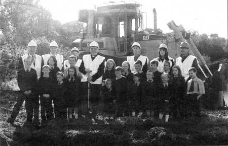 Board of Governors staff and pupils of Ballymacrickett Primary School with parish priest Fr Luke McWilliams, principal Daniel Mulholland and former principal Maureen Loughan, at the cutting of the first sod ceremony.