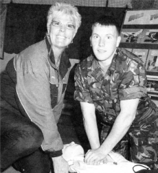 Ms Pauline Crockard (Instructional Officer swimming specialist) instructing Private Wes McGlynn a military driver on turning bystanders into life guards.