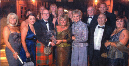Sandra Corkin, Managing Director of Oasis Travel (centre) and her team collect the Tyrone Crystal globe from comedian Fred MacAuley and television personality Angela Rippon