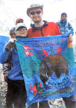 Marian hands a Friends' School flag over to Roger. The flag was designed by Alyson Clarke from Year 8 with the motto 'Seek ye the things that are above'. Roger took the flag with him to place at the summit of Everest.
