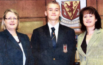 Wallace High School pupil Mark Belshaw who was placed in the top five candidates on the UK in AGA GCSE French, with Head of Modern Foreign Languages Miss Brown and Principal Mrs McBride. US3607-109A0